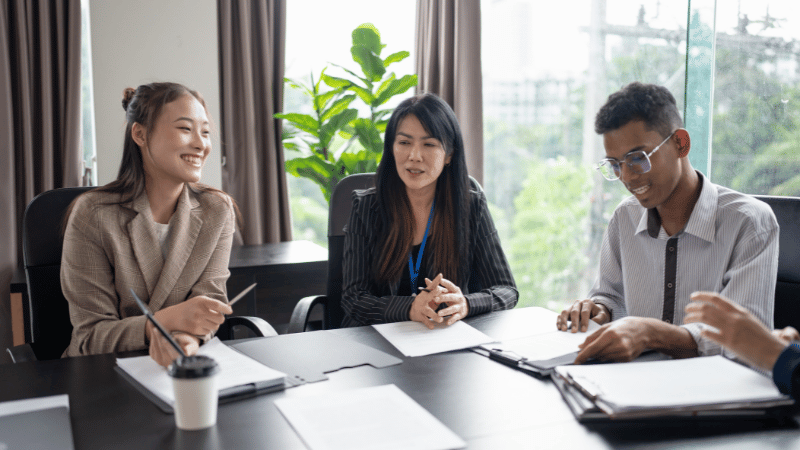 Group of young professionals in a positive meeting with a financial advisor, discussing options for a self-assessment tax loan.